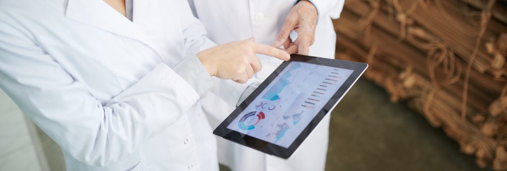 two people holding a tablet to demonstrate data connected to food safety culture and performance metrics.