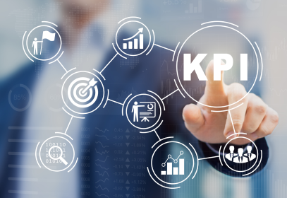 A man wearing a suit pointing to the letters KPI in large bold font, which stands for Key Performance Indicator.