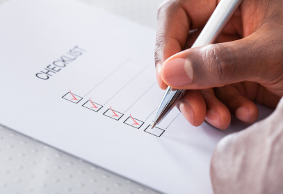 Checklist being checked off with a pen during an internal audit.