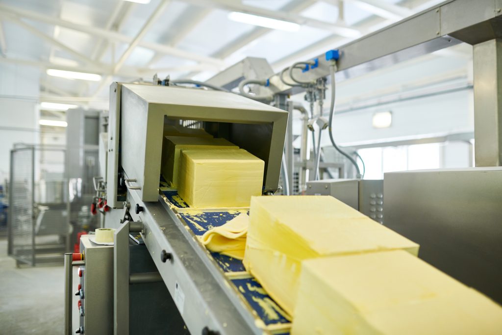 Validation of critical equipment in a butter factory. Close up of a conveyor line in a food manufacturing plant.