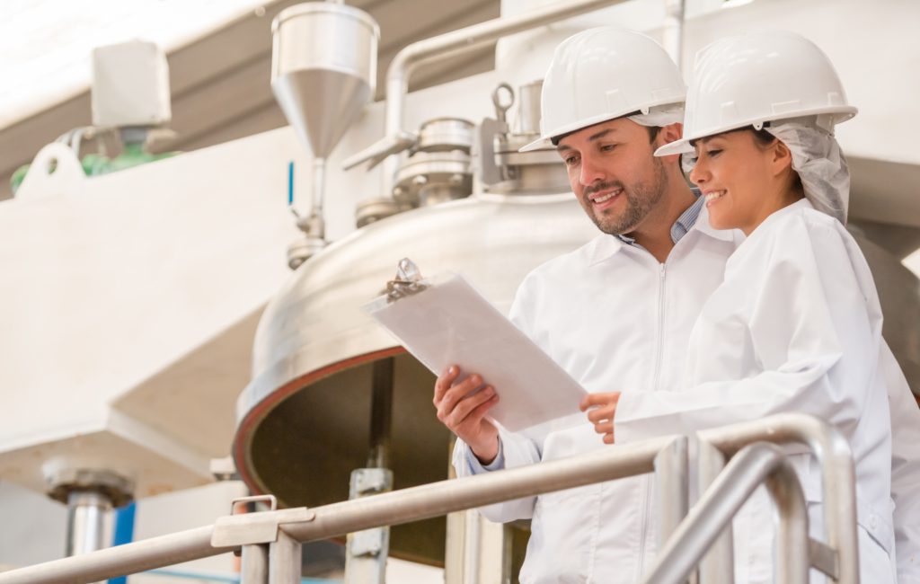 man and woman holding a clipboard on the job.